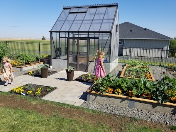 Glass greenhouse with durable garden beds