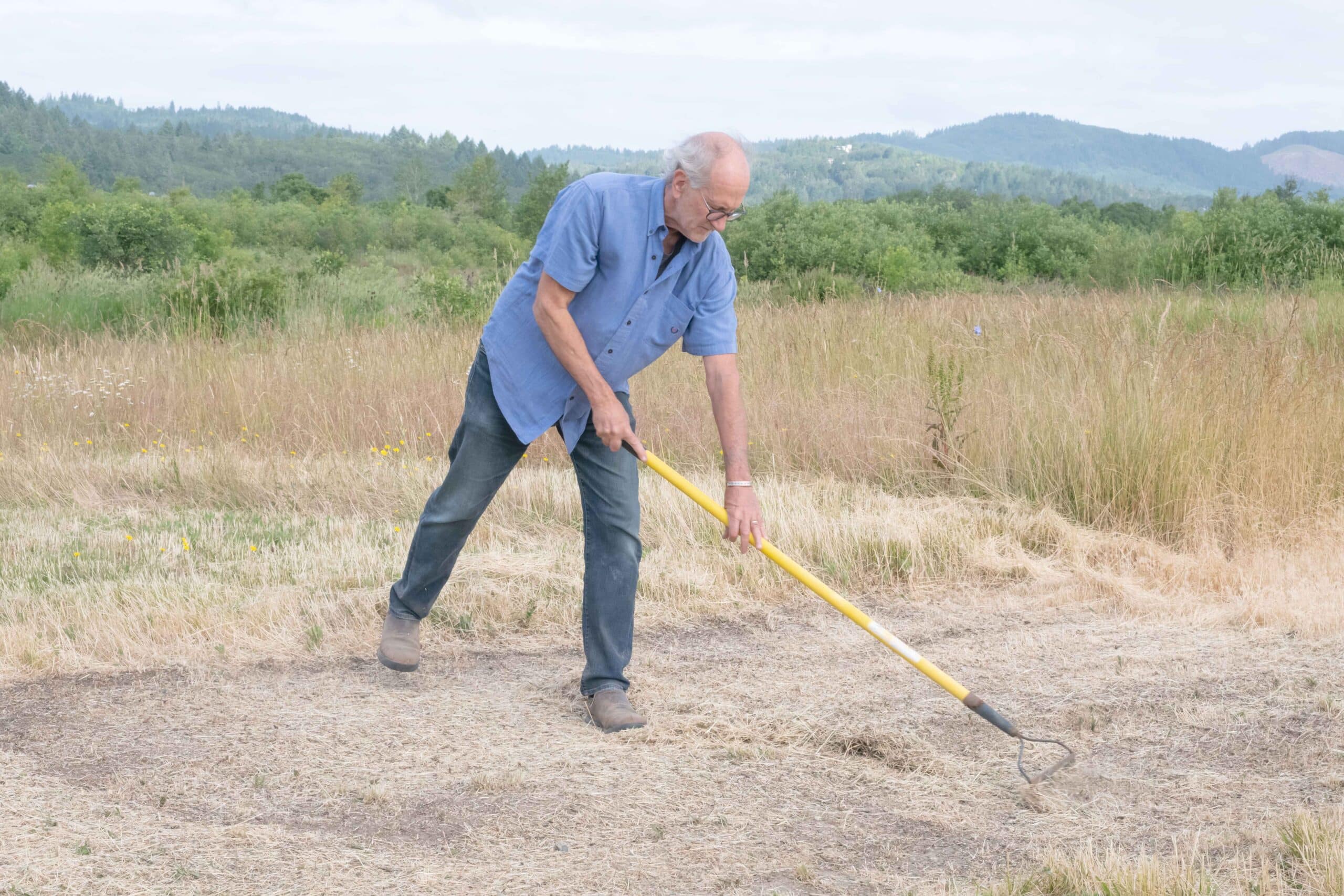 raking to clear ground for bed installation