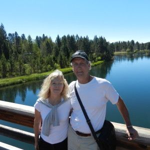 Man and woman standing in front of a body of water