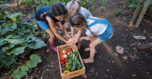 group of school children huddled around garden vegetables